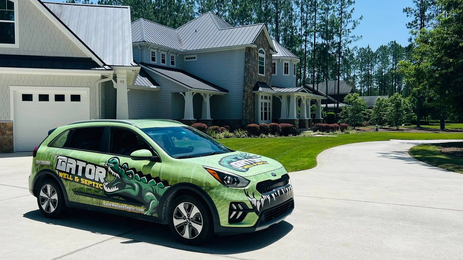 The Gator Well & Septic wrapped service vehicle on a Northeast Florida driveway.