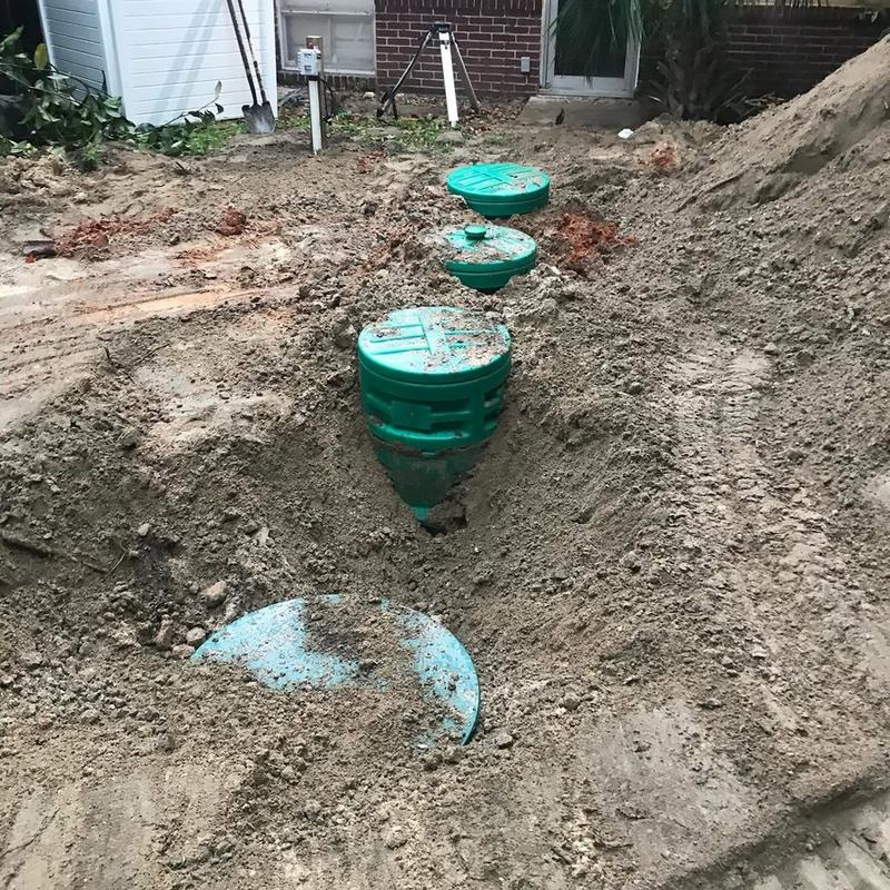 Green tank risers and an access lid brought up to grade in a customer’s yard.